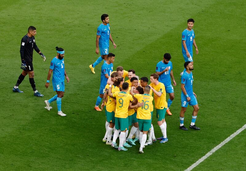 Jordan Bos is mobbed by teammates after scoring Australia's second goal. Reuters
