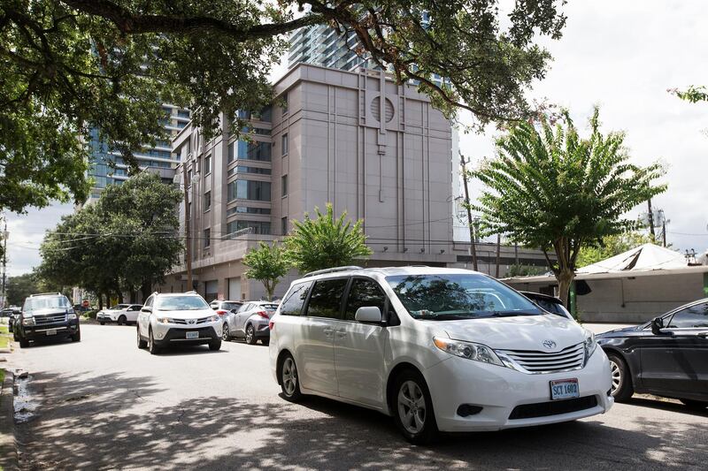A trio of consular vehicles leave the Consulate General of China building late Friday. Houston Chronicle via AP