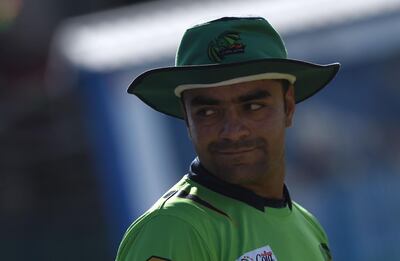 In this photograph taken on September 18, 2017, Afghan national team cricketer Rashid Khan looks on during a match between Kabul Eagles and Band-e-Amir Dragons during the Shpageeza Cricket League T20 tournament at the Kabul International Cricket ground in Kabul.
Thousands of cricket-mad fans have been travelling across the war-torn country to watch the domestic T20 competition. / AFP PHOTO / WAKIL KOHSAR / TO GO WITH 'AFGHANISTAN-CRICKET-T20-CONFLICT' BY MUSHTAQ MOJADDIDI