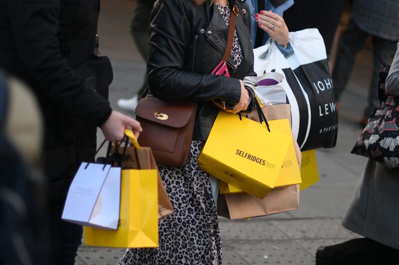 Shoppers carry purchases in Selfridges bags on Black Friday in central London, November 25. AFP