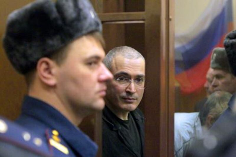 Former head of Russian Yukos oil company Mikhail Khodorkovsky (C) looks from a cage after the reading of his verdict in the Khamovnichesky district court in Moscow. EPA/MAXIM SHIPENKOV