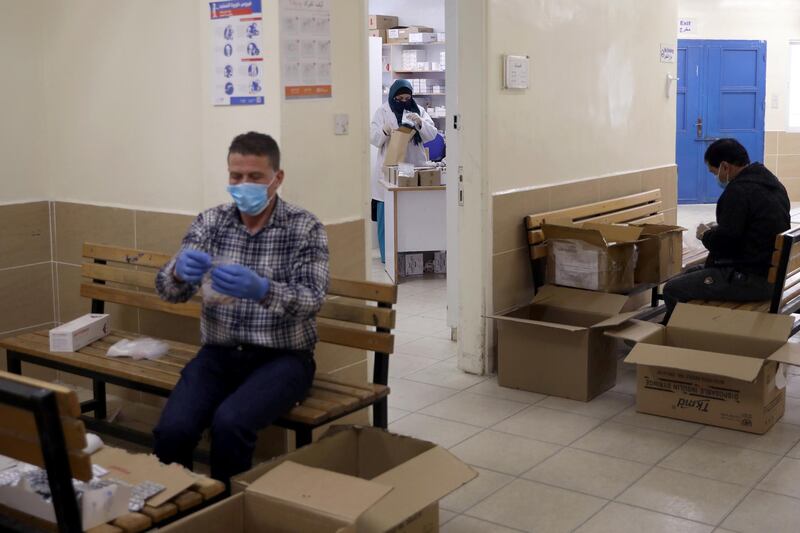 Members of the medical staff at UNRWA prepare prescription medicines to deliver to Palestinian refugees in their homes at Amman New camp amid concerns over the spread of the coronavirus disease. Picture taken April 15, 2020. Reuters