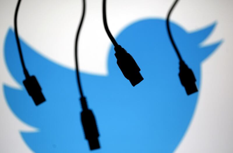 FILE PHOTO: Electronic cables are silhouetted next to the logo of Twitter in this September 23, 2014 illustration photo in Sarajevo.   REUTERS/Dado Ruvic/File Photo