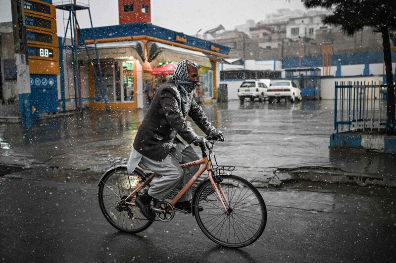 A cyclist sports a dusting of snow.