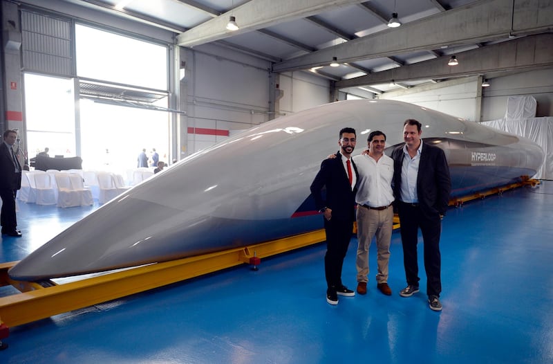 Bibop G. Gresta (L), chairman of Hyperloop Transportation Tech., Airtificial Co-Founder and Chairman, Rafael Contreras (C) and CEO and Co-Founder of Hyperloop Transportation Technologies, Dirk Ahlborn pose next to a full-scale passenger Hyperloop capsule, presented by Hyperloop Transportation Technologies on October 2, 2018 in El Puerto de Santa Maria. A hyperloop is a shuttle that travels on magnetic rails, somewhat like a train, but which runs in a tube with little or no air. In theory, hyperloops could allow travel faster than the speed of sound. Virgin Hyperloop One, backed by British tycoon Richard Branson, has been testing its hyperloop system in Nevada in the United States with speeds reaching 240 miles (386 kilometres) an hour, and is planning three production systems in service by 2021. / AFP / CRISTINA QUICLER
