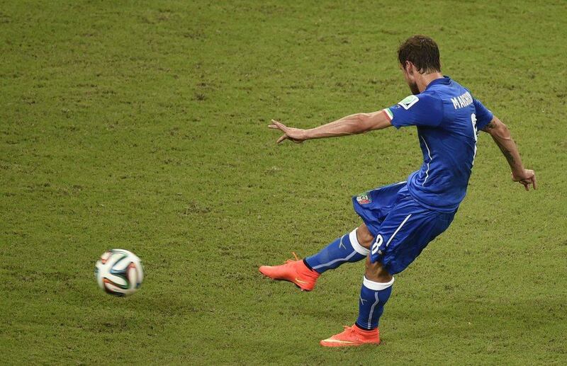 Claudio Marchisio shoots to score Italy's first goal against England on Saturday at the 2014 World Cup. Odd Andersen / AFP