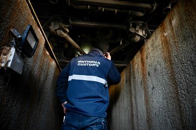 A Bulgarian customs officer inspects a vehicle at Kapitan Andreevo border checkpoint between Bulgaria and Turkey. AFP
