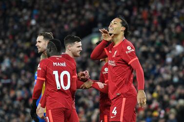 Liverpool's Dutch defender Virgil van Dijk (R) celebrates with teammates after scoring his team's fourth goal during the English Premier League football match between Liverpool and Southampton at Anfield in Liverpool, north west England on November 27, 2021.  (Photo by Oli SCARFF / AFP) / RESTRICTED TO EDITORIAL USE.  No use with unauthorized audio, video, data, fixture lists, club/league logos or 'live' services.  Online in-match use limited to 120 images.  An additional 40 images may be used in extra time.  No video emulation.  Social media in-match use limited to 120 images.  An additional 40 images may be used in extra time.  No use in betting publications, games or single club/league/player publications.   /  