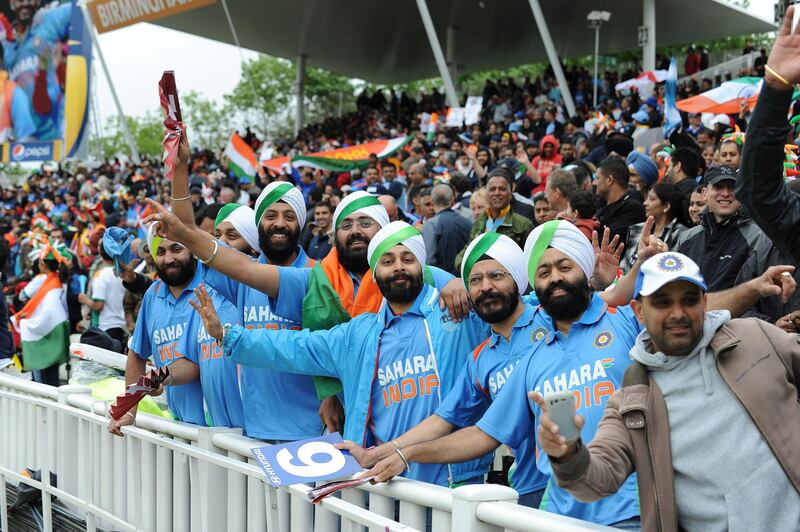 Fans of the Indian cricket team singing in the crowd as rain interupts the start of the 2013 ICC Champions Trophy Final cricket match between England and India at Edgbaston in Birmingham, central England on June 23, 2013. AFP PHOTO/ANDREW YATES - RESTRICTED TO EDITORIAL USE -
 *** Local Caption ***  406181-01-08.jpg