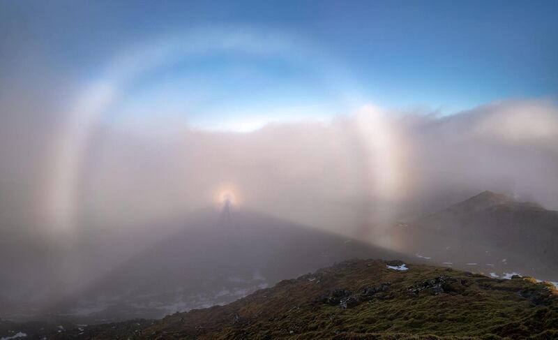 'Ridgeline Optics', Richard Fox: 'After a foggy and snowy climb up onto Meall Nan Tarmachan (Hill of the Ptarmigans) (1043 m), [Scotland,] and along the Tarmachan Ridge, I was greeted, as I ate my lunch on Meall Garbh, to a break in the weather. The sun broke through and behind me a full fog bow, Brocken Spectre and glory. At one point there were multiple glories too.'