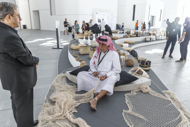 ABU DHABI, UNITED ARAB EMIRATES. 01 DECEMBER 2018. BIGPICTURE OPTION. UAE National Day Program at the Louvre Abu Dhabi. An Emirati man weaves fish nets in a traditional manner. (Photo: Antonie Robertson/The National) Journalist: None. Section: National.