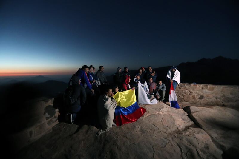 Tourists gather outside a church on the top of Mount Sinai. EPA
