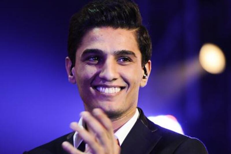 Palestinian singer and winner of "Arab Idol" Mohammed Assaf performs during a concert at the Bahrain International Exhibition & Convention Centre during the Bahrain Summer festival on September 1, 2013 in Manama. The annual festival runs until September 9. AFP PHOTO/MOHAMMED AL-SHAIKH
