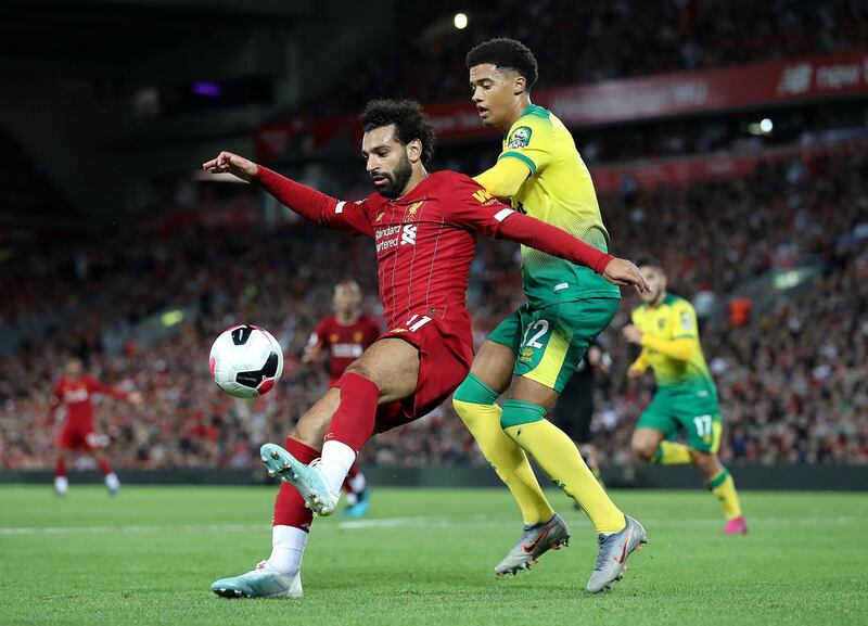 Liverpool forward Mohamed Salah and Norwich City's Jamal Lewis battle for the ball during the Premier League match at Anfield. Press Association