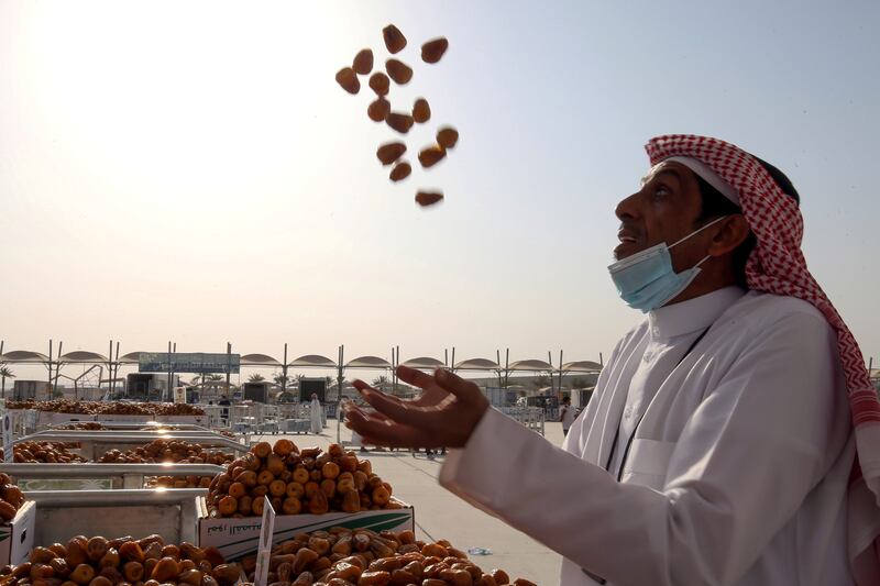 A Saudi farmer displays his dates during the Unaizah Season for Dates at Unaizah city in Al Qassim, Saudi Arabia.