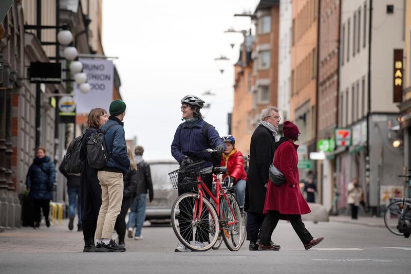 People talk on a street in the Sodermalm district of Stockholm, Sweden, as the spread of the coronavirus continues in the country, on April 1, 2020. Reuters