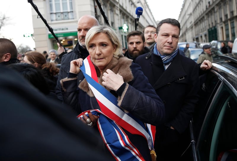 French far-right leader Marine Le Pen arrives to attend a silent march to honor Mireille Knoll, an 85-year-old woman stabbed to death in her Paris apartment, in Paris, France, Wednesday, March 28, 2018. Marine Le Pen has been booed and insulted at a march to honor Mireille Knoll who escaped the Nazis 76 years ago yet was stabbed to death in her Paris apartment, apparently targeted because she was Jewish. (AP Photo/Thibault Camus)