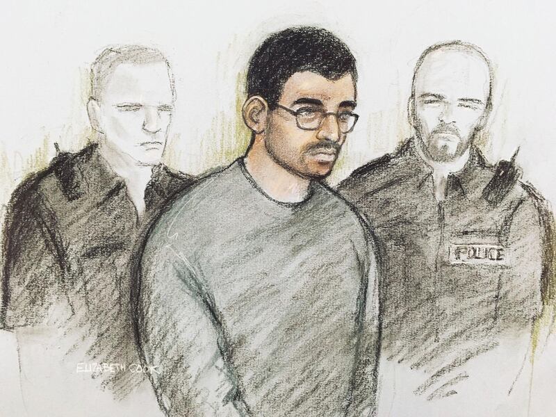 Court artist sketch by Elizabeth Cook of Hashem Abedi in the dock at Westminster Magistrates' Court where he is appearing following his extradition from Libya, in London, Thursday July 18, 2019. The brother of the suicide bomber who killed almost two dozen people at an Ariana Grande concert in Manchester appeared in court Thursday to face 22 charges of murder. (Elizabeth Cook/PA via AP)