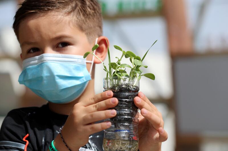 Dubai, United Arab Emirates - Reporter: N/A. Photo project. Children's summer activities. Gabriel makes a aquaponic herb garden at the ultimate eco-friendly summer camp in a bio-dome at the Arbor School. Summer activities for teenagers and children open up after school has finished with Covid-19/Coronavirus protection measures. Wednesday, July 22nd, 2020. Dubai. Chris Whiteoak / The National