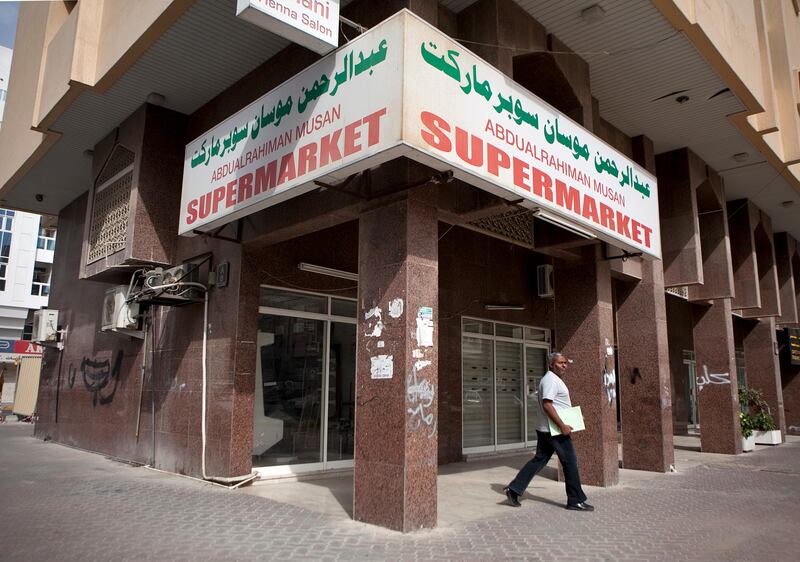Abu Dhabi, United Arab Emirates, January 10, 2013: 
A man walks by the Abdulrahiman Musan Supermarket, a recently closed convenience store on Thursday, Jan. 10, 2013, in the city block between Airport and Muroor, and Delma and Mohamed Bin Khalifa streets in Abu Dhabi. 
Silvia Razgova/The National

