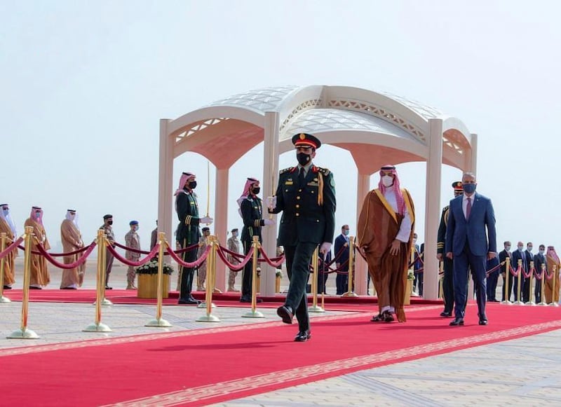 Crown Prince of Saudi Arabia Mohammed bin Salman and Iraq's Prime Minister Mustafa Al Kadhimi walk together on his arrival in Riyadh. SPA