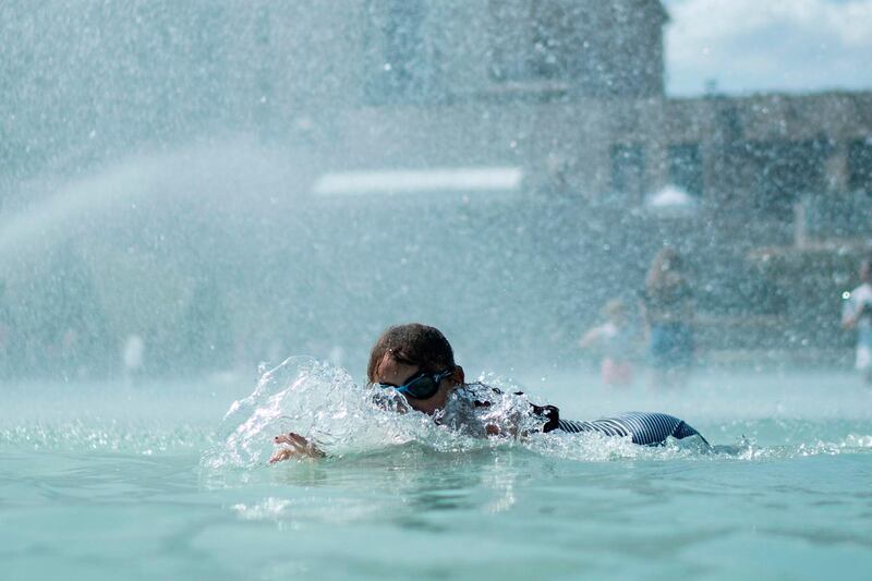 A child swims in the fountain of the Trocadero esplanade in Paris with the Palais de Chaillot on the background. Forecasters say Europeans will feel sizzling heat this week with temperatures soaring as high as 40 degrees Celsius (104 degrees Fahrenheit) in an "unprecedented" June heatwave hitting much of Western Europe. AFP