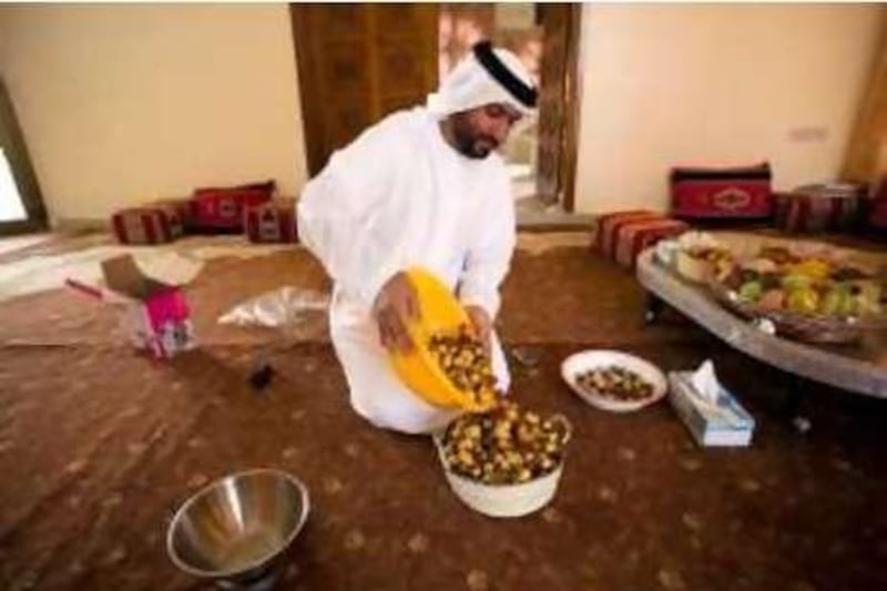 16/07/10 - Abu Dhabi, UAE -  Ahmed Al Murar checks the dates he will enter in the Liwa Date Festival.  Al Murar has won in past at the Liwa Date Festival. (Andrew Henderson/The National)