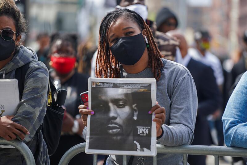 A person holds up a newspaper with a photo of musician and actor Earl Simmons, known as DMX, outside the Barclays Centre in Brooklyn, New York City. Reuters