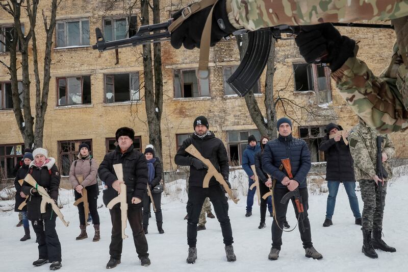 A veteran from the Ukrainian national guard teaches civilians how to handle weapons amid the threat of invasion in Kyiv on January 30. Reuters