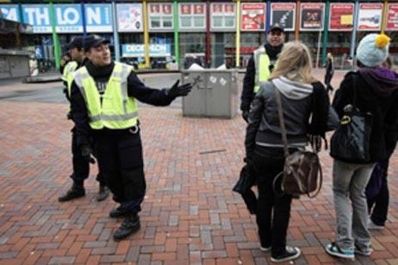 Police give directions to shoppers after sealing off a shopping street in Amsterdam.