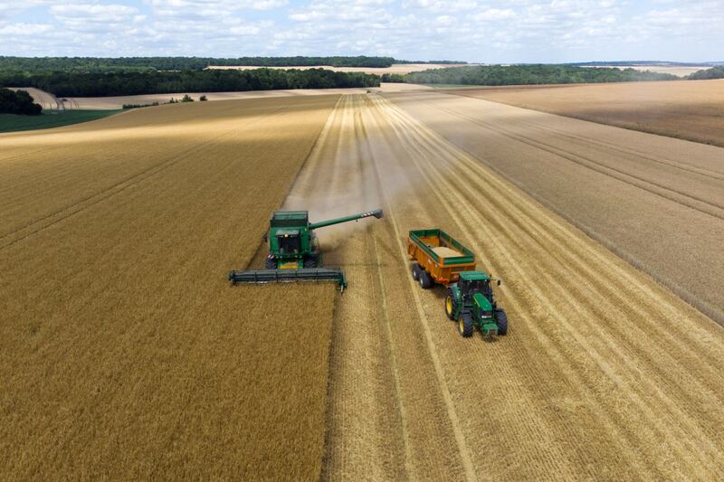A combine harvester unloads barley into a tractor trailer during the harvest in Ailly-sur-Noye, France. Bloomberg