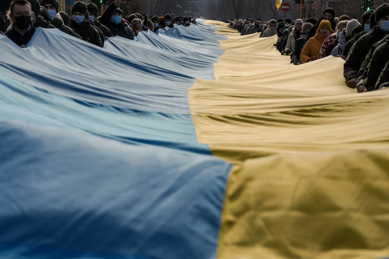 A large Ukrainian flag is carried through Sievierodonetsk. AP Photo