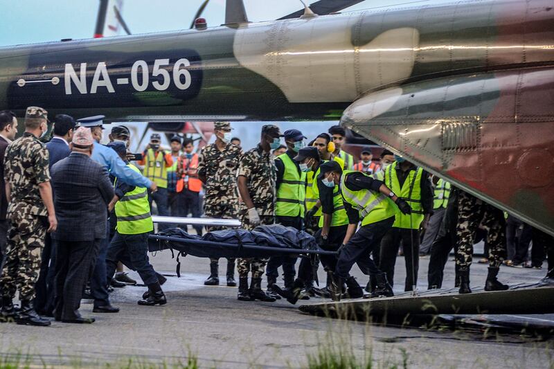 Search crews unload bodies in Kathmandu after they were taken from the wreckage of a plane that crashed with 22 people on board in north-western Nepal. AFP