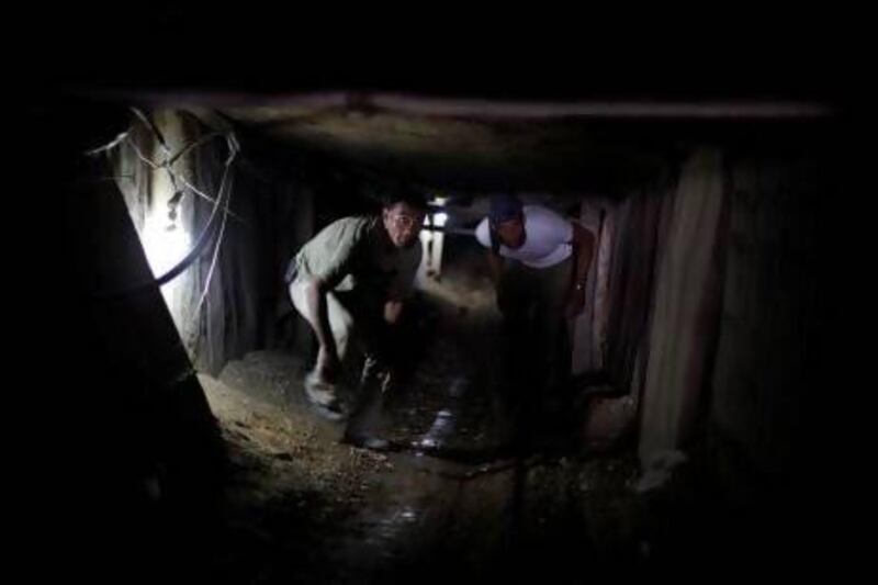 Palestinians inside a smuggling tunnel beneath the Gaza-Egypt border in the southern Gaza Strip.