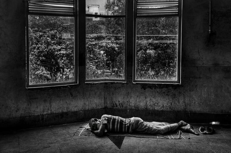 A tired attendant resting in a hospital common area in Bangladesh, amid the pandemic. Photo: Ibrahim Iqbal/ Xposure Photo Festival