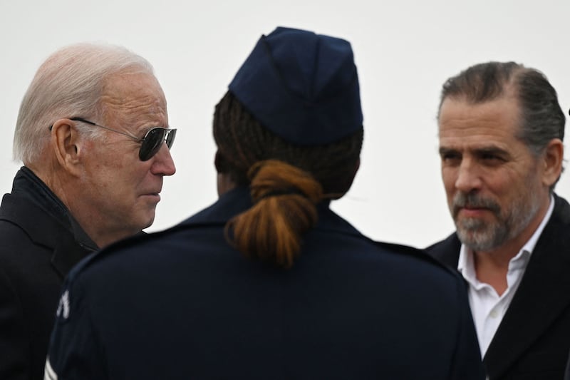 US President Joe Biden and his son Hunter, right, speak to a member of the National Guard in February. AFP