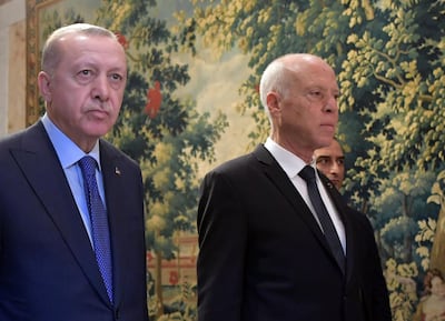 Tunisian President Kais Saied (R) arrives with Turkish President Recep Tayyip Erdogan for a joint press conference at the presidential palace in Carthage, east of the capital Tunis, on December 25, 2019. / AFP / FETHI BELAID
