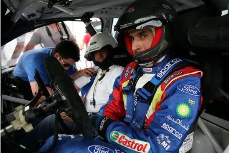 Sheikh Khalid Al Qassimi drove VVIP and press around a rally track at the BP-Ford Abu Dhabi World Rally Team VVIP ÔDrive-Day´ event. Vivek Chaudhary, left, a sports writer for The National rode along. Nicole Hill / The National