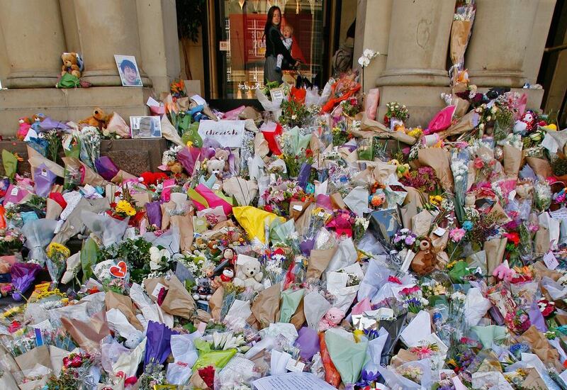 A woman and her child look at floral tributes at Bourke St Mall in Melbourne, Australia. Five people, including an infant, were killed and more than 30 are injured after a man drove his car into pedestrians on Friday. Scott Barbour / Getty Images