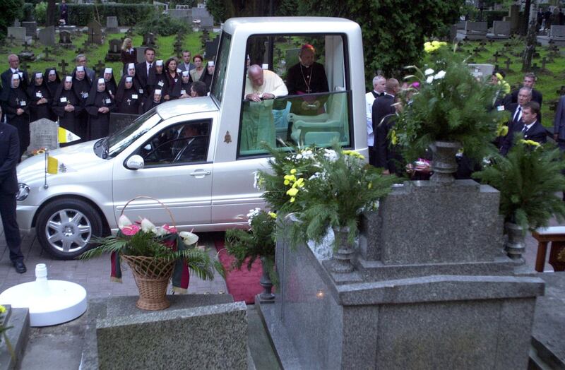 KRAKOW - AUGUST 18:  Pope John Paul II stands in a popemobile which is parked in front of his family tomb August 18 , 2002 in Krakow-Rakovice, Poland. The Pope is in his homeland on the third day of his four-day visit, the ninth during his pontificate.  (Photo by Franco Origlia/Getty Images)