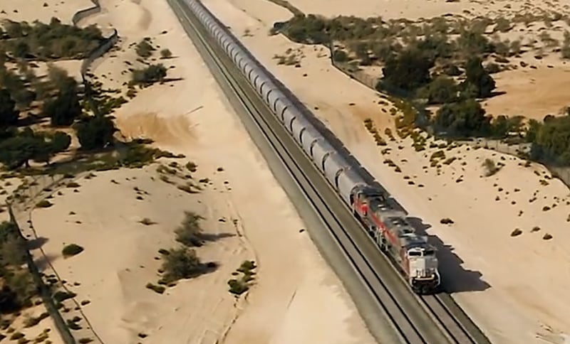 An Etihad Rail train passing through Abu Dhabi emirate. In 2022, we learned more about the planned passenger service, with Etihad Rail stating the first passenger station will be built in Fujairah. A launch date for the passenger service has not been announced. Photo: Etihad Rail