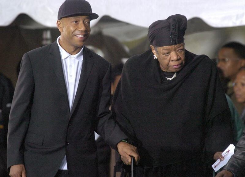 Media mogul Russell Simmons escorts poet Maya Angelou to her seat at the groundbreaking ceremony for the Martin Luther King Jr Memorial on the National Mall in Washington on November 13, 2006 file photo. Jonathan Ernst / Reuters