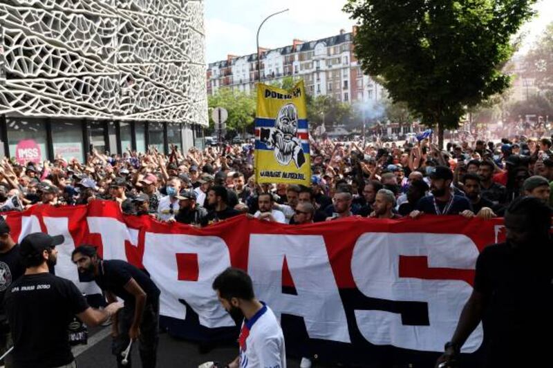 PSG "Ultras" supporters hold a banner outside the Parc des Princes stadium to welcome Lionel Messi,