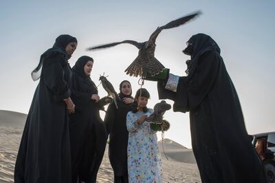 
Emirati Women regularly come together in the evenings to meet and train their birds where the practice becomes more about friendship and sharing knowledge than subsistence. (From left to right) Mariam Al Hammadi, Emam Al Hammadi, Khawla Al Hammadi, Osha Khaleefa Al Mansoori, Ayesha Al Manoori head trainer for the female section in Abu Dhabi Falcon Club, a government-owned organization which promotes falconry in UAE.Vidhyaa for The National
