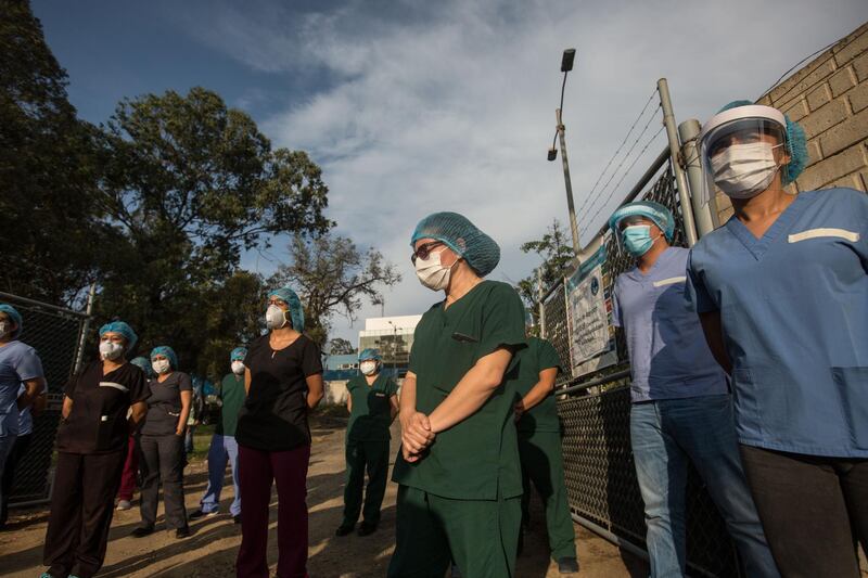 Health personnel from the Villa Nueva National Hospital stand in front of the entrance of the hospital to address a press conference in Villa Nueva, Guatemala. The health personnel treating coronavirus patients threatened to 'enter a permanent session', in which certain areas of service will receive reduced attention, within 48 hours if they do not receive help from the authorities because of the lack of human resources. EPA