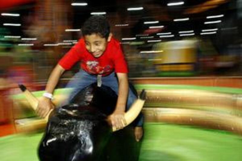 Mohammed Ramadan, 11, rides a mechanical bull at last year's Summer in Abu Dhabi at Adnec.