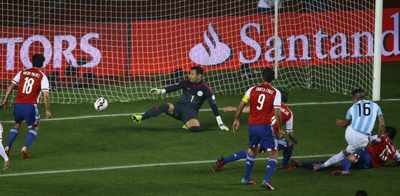 Argentina's Marcos Rojo, right, scores his side's opening goal to make it 1-0 against Paraguay in the Copa America semi-final on Tuesday. Osvaldo Villaroel / EPA