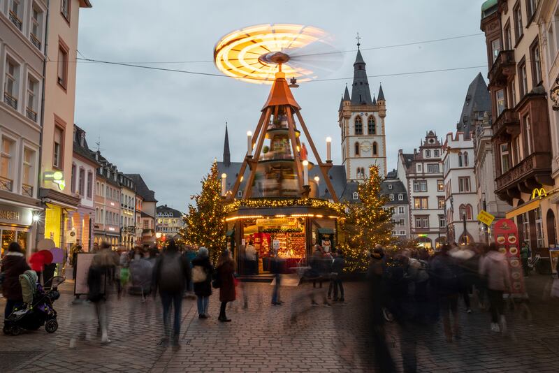 People visit a Christmas market in the German city of Trier. AP