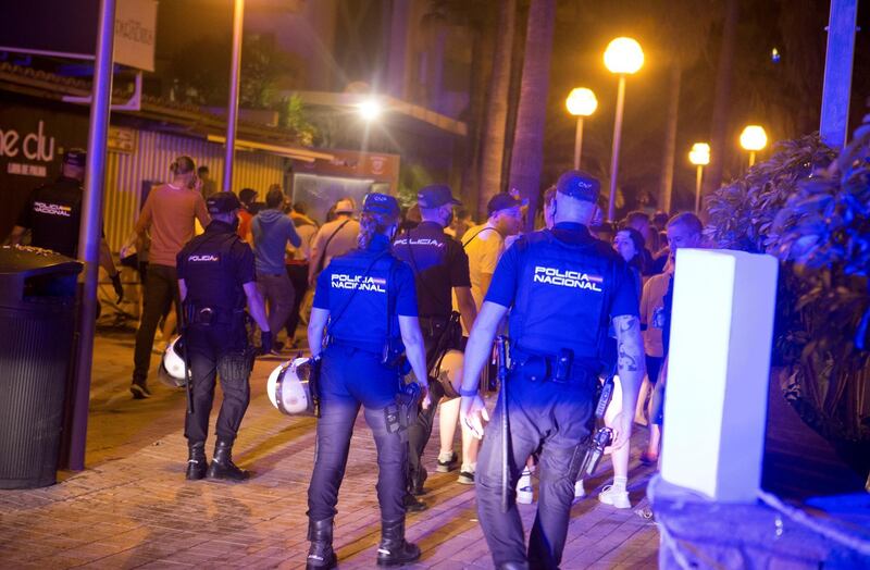 Police officers move people out of the streets to discourage them from crowding, as Spanish regions with a low infection rates were allowed to reopen nightlife facilities, in Mallorca, Spain. Reuters