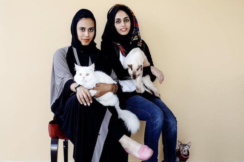 The sisters Iman, left, and Allaa Ahmed Al Aulaqi plan to open Ailuromania Cafe – where visitors can play with cats while enjoying snacks and coffee – by the end of the month. Photos by Rebecca Rees for The National